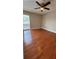This bedroom features wood floors, a ceiling fan, and a bright window at 2763 Woodgate Ln # 210, Sarasota, FL 34231