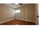 This bedroom features wood floors, a ceiling fan, and a bright window at 2763 Woodgate Ln # 210, Sarasota, FL 34231