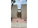 Exterior view between two buildings with manicured landscaping and covered balconies at 2763 Woodgate Ln # 210, Sarasota, FL 34231