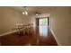 Dining room with wood floors and glass top table at 2763 Woodgate Ln # 210, Sarasota, FL 34231