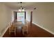Dining room with wood floors and glass top table at 2763 Woodgate Ln # 210, Sarasota, FL 34231