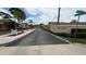 Charming neighborhood entrance with lush landscaping and clear signage for Pinewood Village at 2763 Woodgate Ln # 210, Sarasota, FL 34231