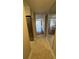 Hallway leading to living area with tile floor and mirror accent at 2763 Woodgate Ln # 210, Sarasota, FL 34231