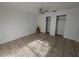 Bedroom featuring neutral walls, closet space, tile flooring, and a ceiling fan at 2802 Jamaica St, Sarasota, FL 34231