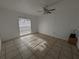 Bedroom with tile flooring, ceiling fan, and natural light, providing a comfortable space at 2802 Jamaica St, Sarasota, FL 34231