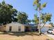 Charming single-story home featuring a well-maintained lawn, mature tree, and a welcoming front entrance at 2802 Jamaica St, Sarasota, FL 34231