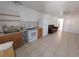 Functional kitchen with oak cabinetry, white appliances, and ample counter space for meal preparation at 2802 Jamaica St, Sarasota, FL 34231