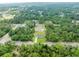 Aerial view showcasing the property's location on a wooded lot at 343 Tenk St, Port Charlotte, FL 33953