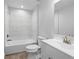 Clean bathroom featuring tile flooring, a sleek vanity, toilet, and a combined tub and shower at 343 Tenk St, Port Charlotte, FL 33953