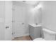 Well-lit bathroom with gray vanity, toilet, and modern mirror at 343 Tenk St, Port Charlotte, FL 33953
