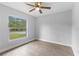 Bedroom showcasing a large window offering an outdoor view and wood-look tile flooring at 343 Tenk St, Port Charlotte, FL 33953