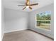Bedroom showcasing a large window offering an outdoor view and wood-look tile flooring at 343 Tenk St, Port Charlotte, FL 33953