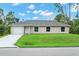 Charming single-story home with a manicured lawn, paved driveway, and neutral stucco exterior at 343 Tenk St, Port Charlotte, FL 33953