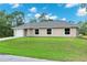 Charming single-story home with a well-manicured lawn and an attached garage at 343 Tenk St, Port Charlotte, FL 33953