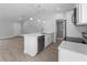 Modern kitchen with white cabinets, a breakfast bar, and stainless steel appliances at 343 Tenk St, Port Charlotte, FL 33953