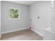 Laundry room featuring wood-look tile flooring and a window at 343 Tenk St, Port Charlotte, FL 33953