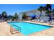 Refreshing community pool with ample seating and shade, ideal for enjoying sunny days at 3740 Gulf Of Mexico Dr # 116, Longboat Key, FL 34228