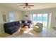 Comfortable living room showcasing a sectional sofa, accent chair, and sliding glass doors with harbor views at 3740 Gulf Of Mexico Dr # 116, Longboat Key, FL 34228