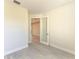 Bedroom featuring light neutral paint, stylish flooring and a clear glass door at 380 Holly Rd, Venice, FL 34293