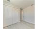 Bedroom featuring a closet, light neutral paint, stylish flooring and an open doorway at 380 Holly Rd, Venice, FL 34293
