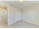 Bright bedroom featuring a double door closet and neutral paint, with stylish marble-look tile floors at 380 Holly Rd, Venice, FL 34293