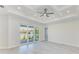 Bright bedroom with sliding glass doors to patio and elegant tray ceiling with fan at 380 Holly Rd, Venice, FL 34293