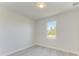 Bedroom with tile floors, natural light, and minimalist decor at 380 Holly Rd, Venice, FL 34293