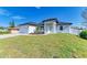Inviting home showcasing a well-manicured lawn, bright white exterior, and neat landscaping at 380 Holly Rd, Venice, FL 34293