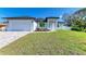 Charming single-story home with a fresh green lawn, clean white exterior, and well-kept landscaping at 380 Holly Rd, Venice, FL 34293