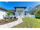 Welcoming entrance with stone walkway, pretty landscaping, and a covered porch at 380 Holly Rd, Venice, FL 34293