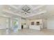 Modern kitchen featuring white cabinets, stainless steel appliances, and a stylish island with seating at 380 Holly Rd, Venice, FL 34293