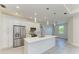 Modern kitchen features stainless steel appliances, white cabinetry, and center island at 380 Holly Rd, Venice, FL 34293