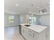 Modern kitchen with island, stainless dishwasher, sink and quartz countertop at 380 Holly Rd, Venice, FL 34293