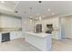 Eat-in kitchen island, stainless steel appliances, tile backsplash, and wine cooler at 380 Holly Rd, Venice, FL 34293