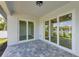 Covered patio featuring a paver floor and large sliding glass doors for indoor-outdoor living at 380 Holly Rd, Venice, FL 34293