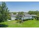 Aerial view of a property featuring lush landscaping, an expansive lawn, and a screened-in pool at 3806 155Th E Ave, Parrish, FL 34219