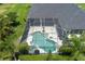 Aerial view of the backyard pool features a hot tub and tropical landscaping at 3806 155Th E Ave, Parrish, FL 34219