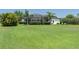Expansive lush backyard featuring a screened pool enclosure and lounge chairs at 3806 155Th E Ave, Parrish, FL 34219