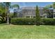 Large backyard features a screened pool enclosure and a meticulously kept lawn at 3806 155Th E Ave, Parrish, FL 34219