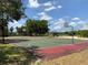 Community basketball court with playground equipment and mature trees in the background at 3806 155Th E Ave, Parrish, FL 34219