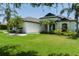 Charming single-story home with lush landscaping and well-maintained lawn and white painted brick at 3806 155Th E Ave, Parrish, FL 34219