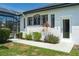 Exterior of home with lush front yard, garden, a side entrance, and screened in pool area at 3806 155Th E Ave, Parrish, FL 34219