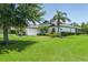 Well-manicured lawn and landscaping enhance the curb appeal of this property at 3806 155Th E Ave, Parrish, FL 34219