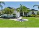 Beautifully landscaped front yard featuring a circular walkway and palm trees at 3806 155Th E Ave, Parrish, FL 34219