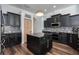 Stylish kitchen featuring black cabinets, a mosaic backsplash, and stainless steel appliances at 3806 155Th E Ave, Parrish, FL 34219