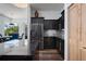 Modern kitchen with black cabinets, stainless steel refrigerator, and adjacent dining area at 3806 155Th E Ave, Parrish, FL 34219