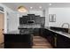 Modern kitchen featuring black cabinets, a mosaic backsplash, and stainless steel appliances at 3806 155Th E Ave, Parrish, FL 34219