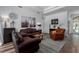 Cozy living room with leather furniture, hardwood floors, and abundant natural light at 3806 155Th E Ave, Parrish, FL 34219