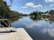 Scenic water view from the community dock with lush trees and blue skies at 3806 155Th E Ave, Parrish, FL 34219