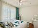 Bedroom featuring bright natural light, ceiling fan, and decorative bedspread at 4122 Central Sarasota Pkwy # 1923, Sarasota, FL 34238